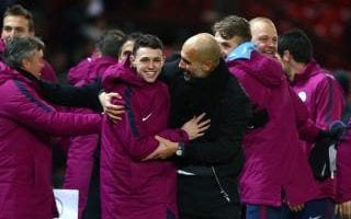 Guardiola and Man City players and staff members celebrate their win over United