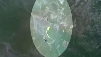 Unmanned aircraft drops flotation device to swimmers struggling in rip current in Australia.