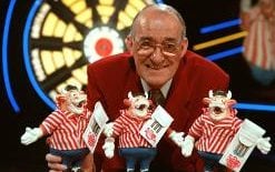 Jim Bowen with the 'bendy bullies' given to Bullseye contestants as consolation prizes
