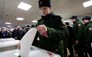 Russian military personnel cast their ballots in the presidential election in Moscow, Russia