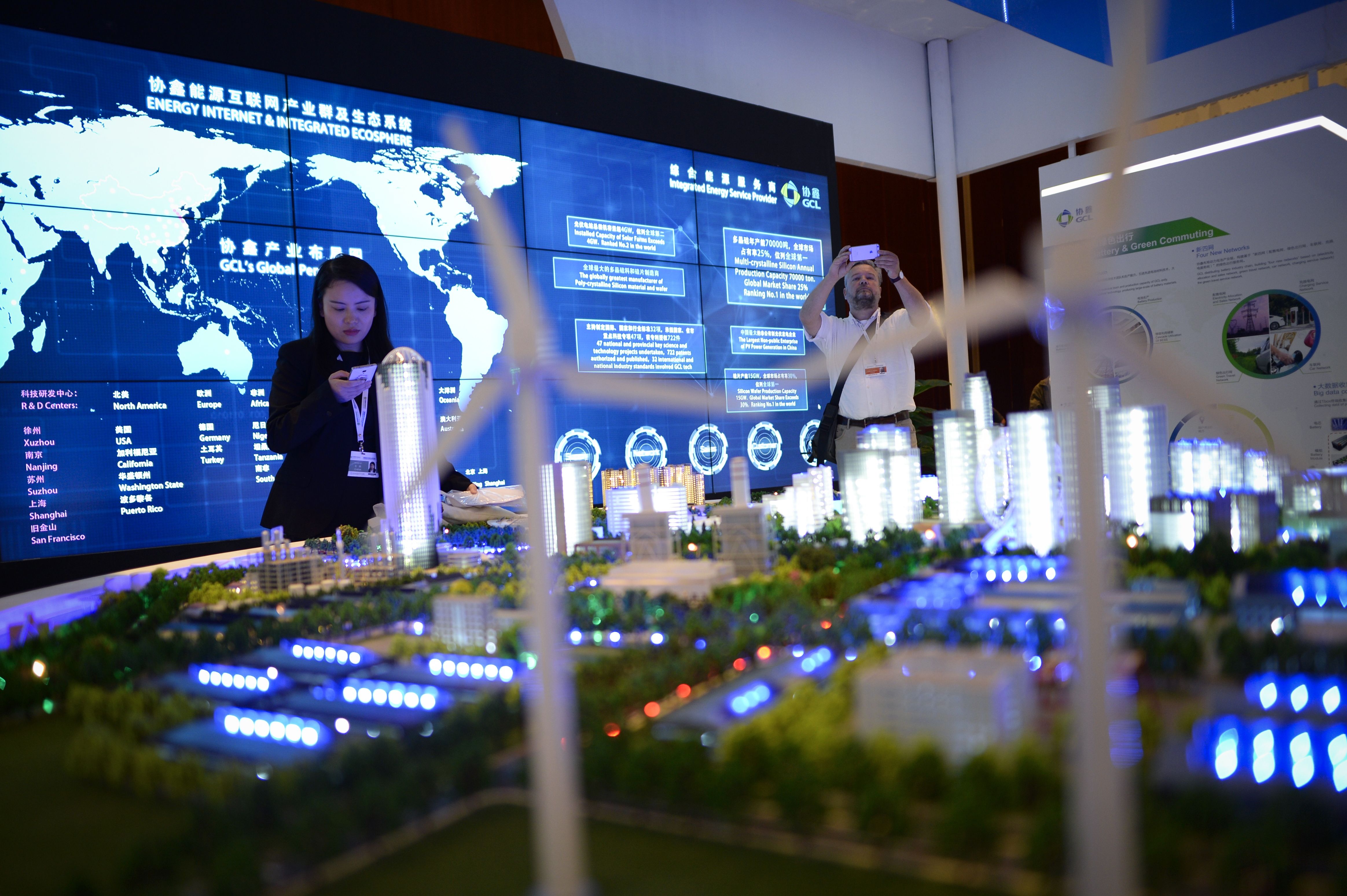 People visit a clean energy exhibition on the sidelines of the Clean Energy Ministerial international forum in Beijing on June 6, 2017.
                Officials and business leaders from around the world have gathered for the clean energy ministerial meeting in the Chinese capital.