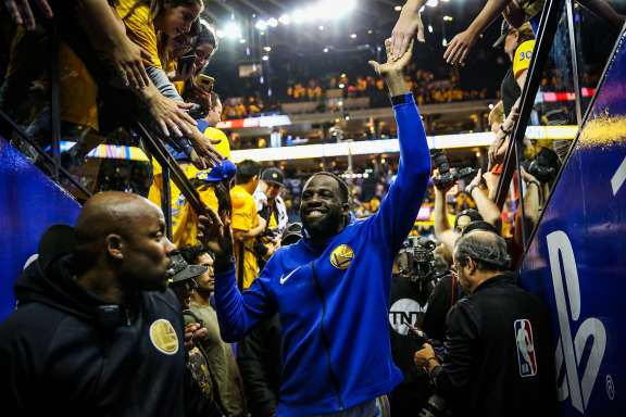 Draymond Green high-fives fans after winning Game 3 of the Western Conference Finals between the Golden State Warriors and the Houston Rockets at Oracle Arena in Oakland, California, on Sunday, May 20, 2018.