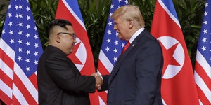 U.S. President Donald Trump shakes hands with North Korea leader Kim Jong Un at the Capella resort on Sentosa Island Tuesday, June 12, 2018 in Singapo