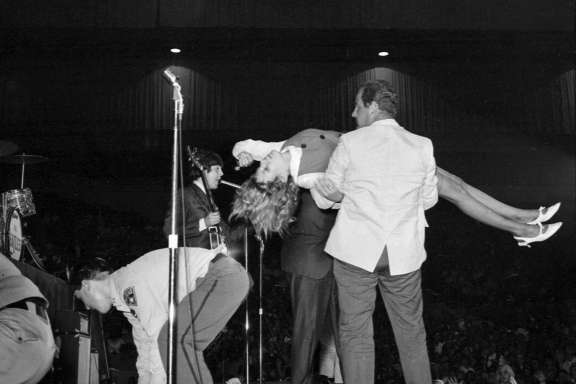 The Beatles are mobbed by fans at the Cow Palace in August 1965.