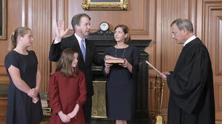 Chief Justice John Roberts, right, administers the Judicial Oath to Judge Brett Kavanaugh in the Justices' Conference Room of the Supreme Court Building. Ashley Kavanaugh holds the Bible. At left are their daughters, Margaret, background, and Liza. (Fred Schilling/Collection of the Supreme Court of the United States via AP)