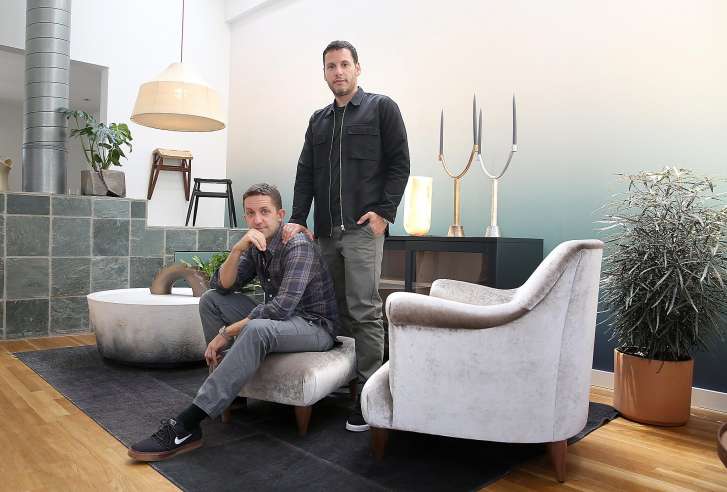 Jason Duzansky (left) and owner David Alhadeff (right) show their living room at home on Thursday, May 10, 2018 in San Francisco, Calif.