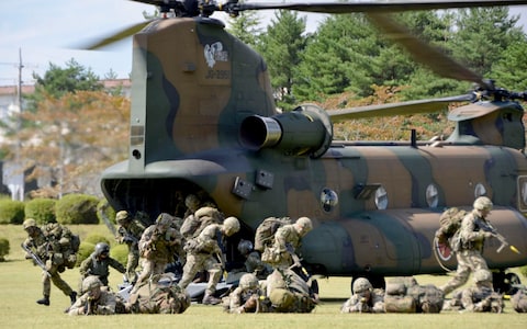 Members of British Army and Japan Ground Self-Defense Force disembark from a helicopter during their first-ever joint exercise on Japanese soil in Oyama, Shizuoka prefecture, Tuesday, Oct. 2, 2018.