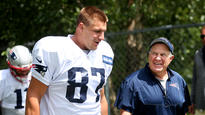 Rob Gronkowski and coach Bill Belichick share a laugh as they head onto the practice field during Patriots training camp in July.  Staff photo by Nancy Lane