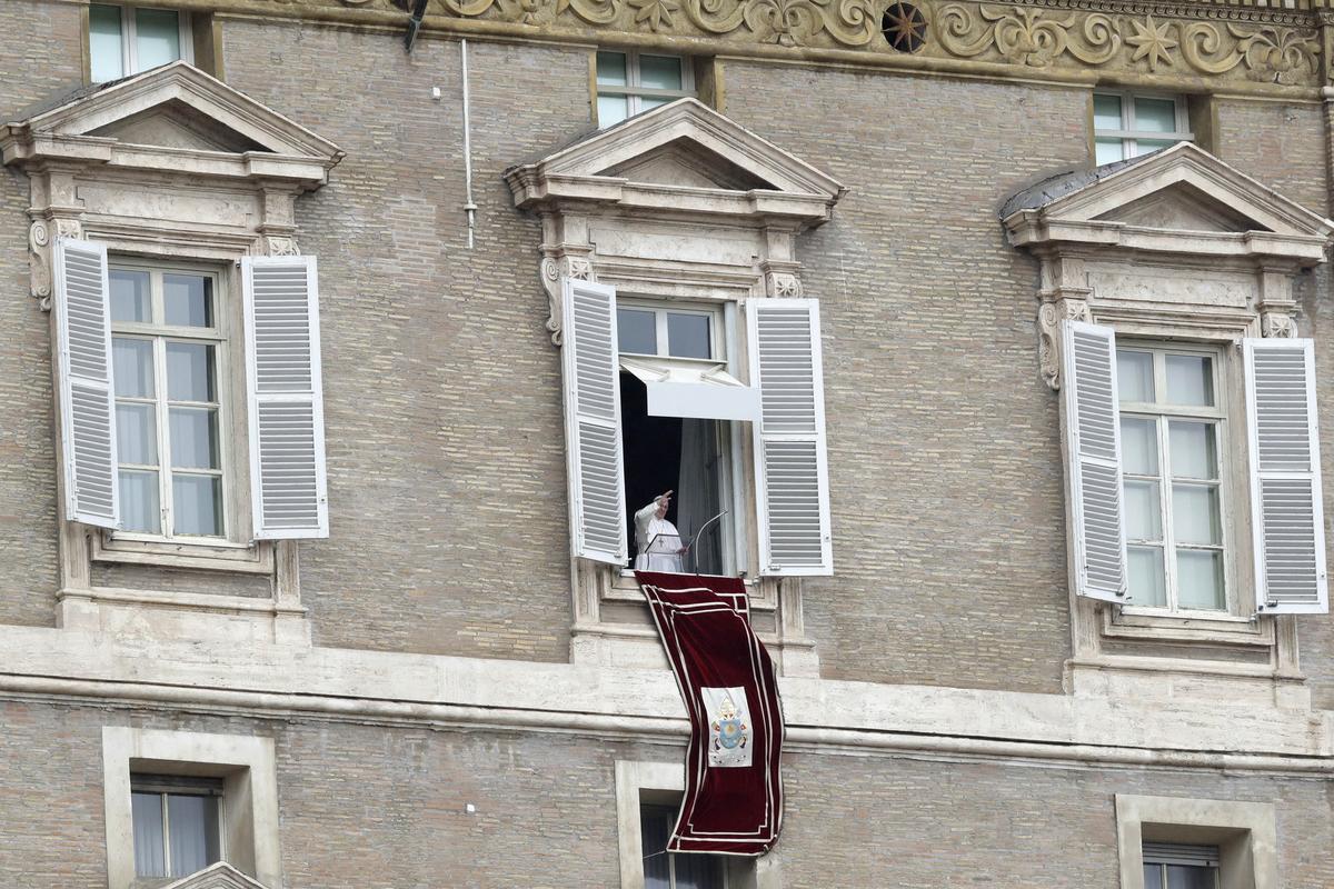 Pope Francis delivers his blessing from his studio window overlooking St. Peter's Square, at the Vatican, Sunday, Oct. 28, 2018. Francis is grieving with Pittsburgh's Jewish community following the massacre at a synagogue, denouncing the "inhuman act of violence" and praying for an end to the "flames of hatred" that fueled it. (AP Photo/Andrew Medichini)
            