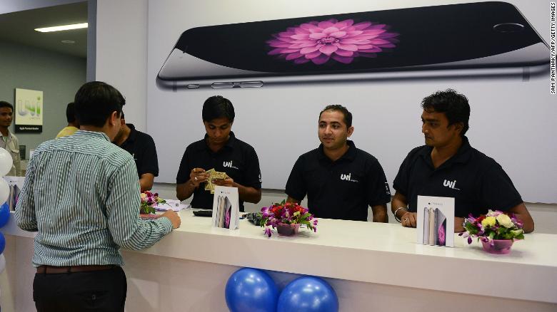 An Indian customer waits to receive his Apple iPhone 6 at the Unicorn Infosolutions Apple Premium Reseller store in Ahmedabad early on October 17, 2014.  Apple launched the iPhone 6 and iPhone 6 Plus smartphones in India at midnight on October 17.  AFP PHOTO / Sam PANTHAKY        (Photo credit should read SAM PANTHAKY/AFP/Getty Images)