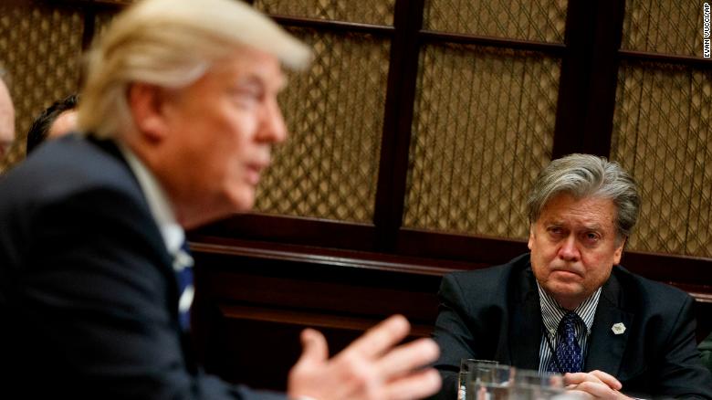 White House Chief Strategist Steve Bannon listens at right as President Donald Trump speaks during a meeting on cyber security in the Roosevelt Room of the White House in Washington, Tuesday, January 31, 2017.