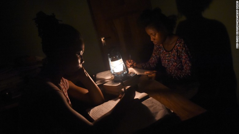Students study with a kerosene lamp due to epileptic public power supply in Lagos on September 24, 2016.
.