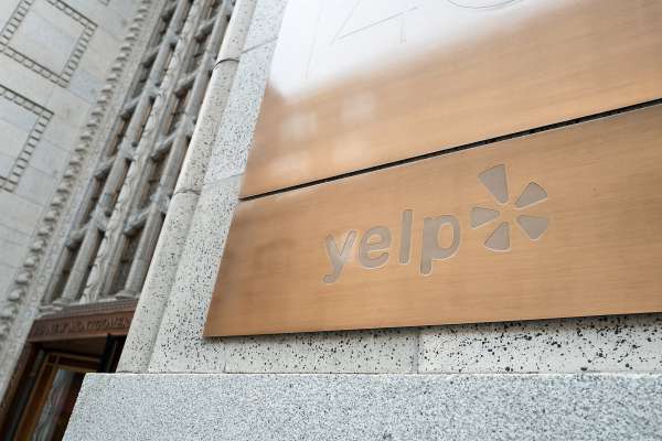 Sign at the headquarters of social reviews site Yelp in the South of Market (SoMa) neighborhood of San Francisco, California, October 13, 2017. SoMa is known for having one of the highest concentrations of technology companies and startups of any region worldwide. (Photo by Smith Collection/Gado/Getty Images)