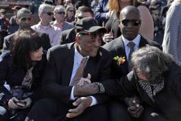 Deb Perry, wife of Gaylord Perry, right, reaches over to shake hands with Willie Mays during a public remembrance for Willie McCovey at AT&T Park in San Francisco, Calif., on Thursday, November 8, 2018.