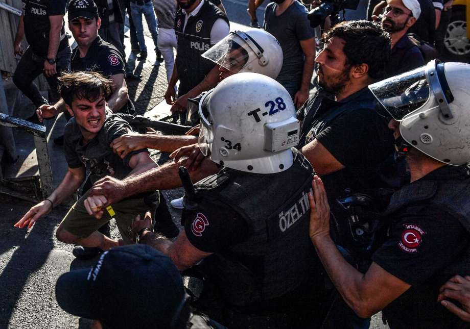 Turkish riot officers beat a gay rights activist after Pride parade organizers refused to recognize a ban by the city of Istanbul. Photo: Bulent Kilic / AFP / Getty Images / AFP or licensors