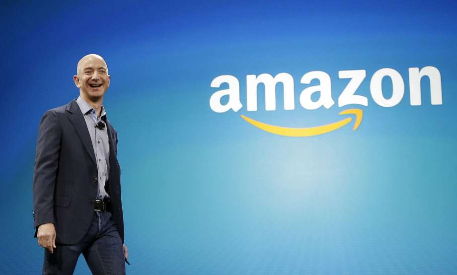 FILE - In this June 16, 2014 file photo, Amazon CEO Jeff Bezos walks on stage for the launch of the new Amazon Fire Phone, in Seattle. Amazon.com reports quarterly financial results on Thursday, Oct. 23, 2014. (AP Photo/Ted S. Warren, File) Photo: Ted S. Warren, Associated Press