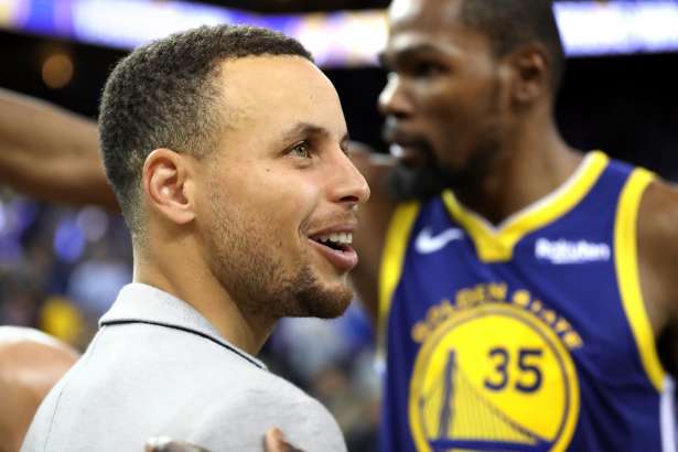 Golden State Warriors' Stephen Curry and Kevin Durant after 116-110 win over Orlando Magic during NBA game at Oracle Arena in Oakland, Calif. on Monday, November 26, 2018.