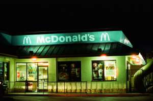a store front at night: McDonald’s employees in Sarasota, Fla., reopened the store for two girls after their father was arrested. (Photo: Smith Collection/Gado/Getty Images)
