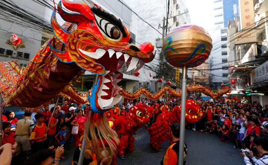 Prayers and performances mark Lunar New Year as Chinese communities in Asia welcome 'Year of the Pig'