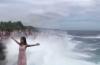 Huge wave sweeps away girl posing on cliff