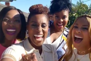 Black women of various shades laugh in the sunlight