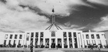 Parliament House in Canberra with helicopters flying overhead