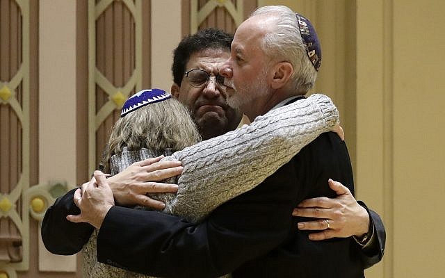 Rabbi Jeffrey Myers, right, of Tree of Life/Or L'Simcha Congregation hugs Rabbi Cheryl Klein, left, of Dor Hadash Congregation and Rabbi Jonathan Perlman during a community gathering held in the aftermath of a deadly shooting at the Tree of Life Synagogue in Pittsburgh, Oct. 28, 2018. (AP Photo/Matt Rourke)