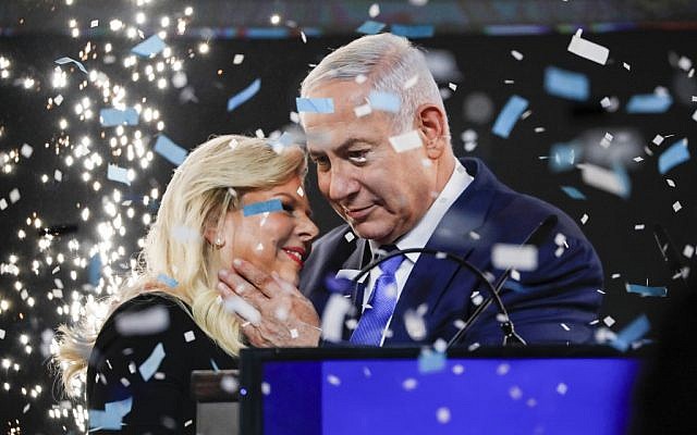 Prime Minister Benjamin Netanyahu embraces his wife Sara amid confetti during his victory speech before supporters at Likud party headquarters in Tel Aviv after April 9, 2019's elections. (Thomas Coex/AFP)