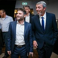 Union of Right-Wing Parties leader Rafi Peretz (R) and MK Bezalel Smotrich are greeted by supporters at the party headquarters, April 09, 2019. (Flash90)