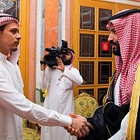 Saudi Crown Prince Mohammed bin Salman (right) shakes hands with Salah Khashoggi, a son of Jamal Khashoggi, in Riyadh, Saudi Arabia, October 23, 2018. (Saudi Press Agency via AP)