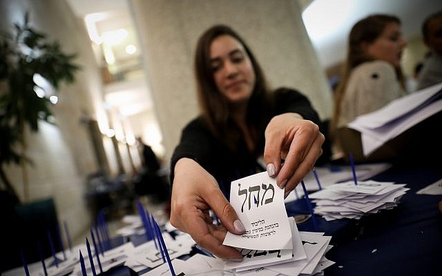 Officials count the remaining ballots from soldiers and absentees at the Knesset in Jerusalem, a day after the general elections, April 10, 2019. (Noam Revkin Fenton/Flash90)