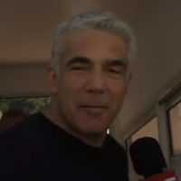 Blue and White No. 2 Yair Lapid speaks to a reporter from Channel 12 outside his home in Tel Aviv on April 10, 2019. (Screen capture: Channel 12)