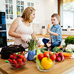 Mother and son cooking with vegetables and fruits