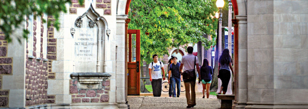 students walking through an archway on Danforth Campus