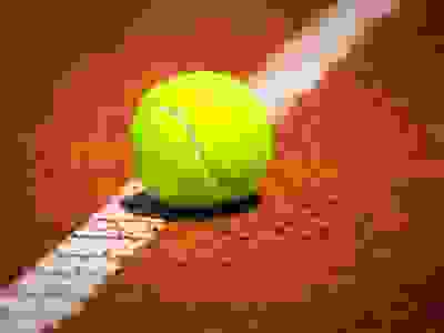 Green Tennis Ball on a tennis court