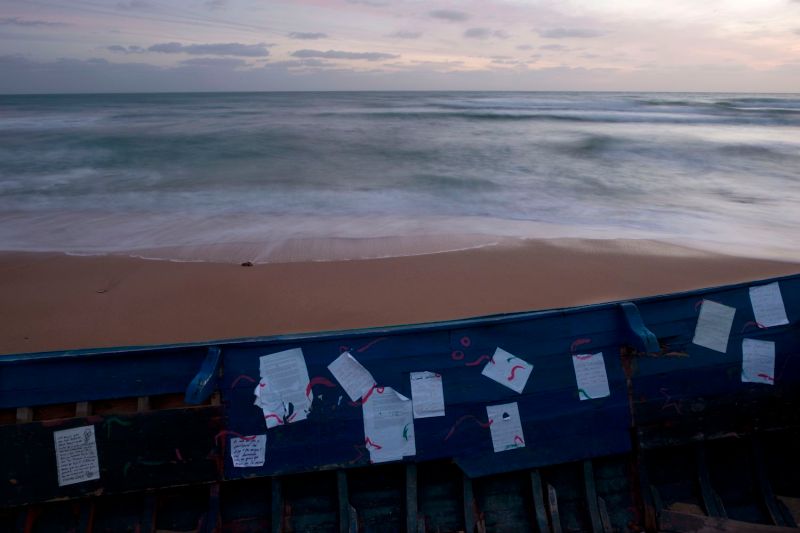 Handwritten notes are stuck on a boat used by migrants on Los Caños de Meca beach near Barbate, Spain, on Nov. 26, 2018.