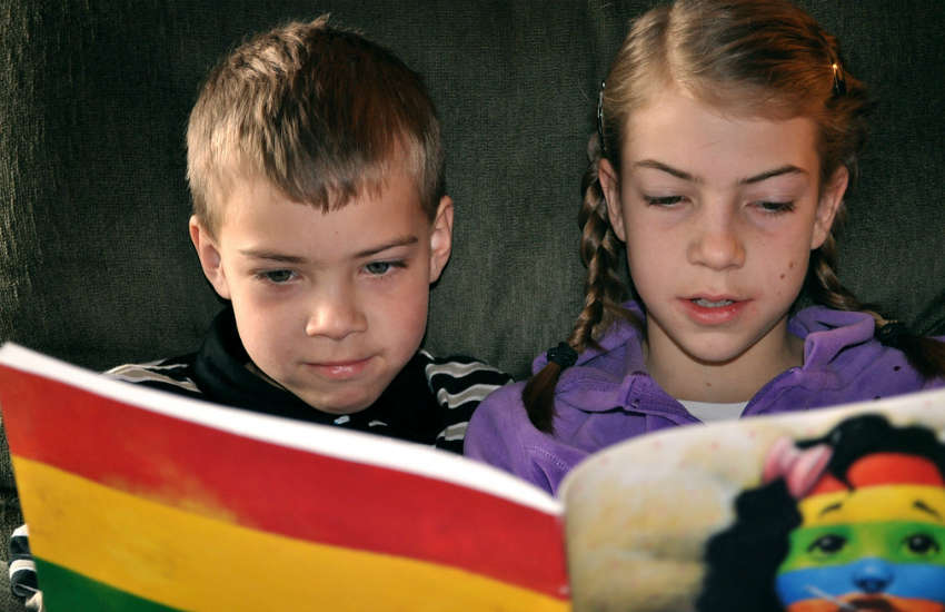 Kids reading a book together