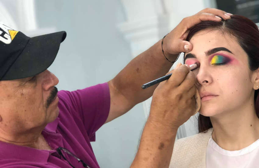 Don Raúl Santiago practices makeup skills in Deysbel Olachea's class