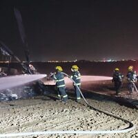 Firefighters work to extinguish a blaze on a helicopter that made an emergency landing in a field outside of Rahat in the Negev desert on November 26, 2019. (Fire and Rescue Services)