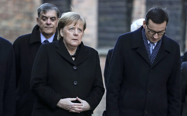 German Chancellor Angela Merkel and Polish Prime Minister Mateusz Morawiecki, from left, visit the former Nazi death camp of Auschwitz-Birkenau in Oswiecim, Poland on Friday, Friday, Dec. 6, 2019. Merkel attend an event in occasion of the 10th anniversary of the founding of the Auschwitz Foundation. (Photo/Markus Schreiber via AP)