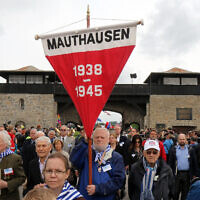 Members of the international Mauthausen committee arrive for a ceremony to commemorate the 70th anniversary of the liberation of the Nazi concentration camp in Mauthausen, Austria, Sunday, May 10, 2015. . (AP Photo/Ronald Zak)