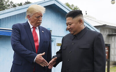 North Korean leader Kim Jong Un (R) and US President Donald Trump prepare to shake hands at the border village of Panmunjom in the Demilitarized Zone, South Korea, June 30, 2019. (AP Photo/Susan Walsh, File)