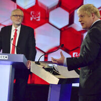 Opposition Labour Party leader Jeremy Corbyn, left, and British Prime Minister Boris Johnson, during a head to head live Election Debate at the BBC TV studios in Maidstone, England,  December 6, 2019. ( Jeff Overs/BBC via AP)