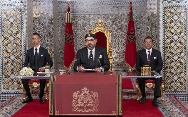 In this photo provided by the Moroccan News Agency (MAP), Morocco's King Mohammed VI, center, accompanied by his son Crown Prince Moulay Hassan, left, and brother Prince Moulay Rashid addresses the Nation in a speech aired on TV, at the Royal Palace in Tetouan, Morocco, on Monday July 29, 2019. (Moroccan Royal Palace via AP)