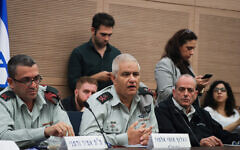 Commander of the IDF Manpower Directorate Maj. Gen. Moti Almoz, center, and the head of the Manpower Directorate's Planning and Manpower Management Division, Brig. Gen. Amir Vadamni, left, attend a Defense and Foreign Affairs Committee in the Knesset on December 9, 2019. (Yonatan Sindel/Flash90)