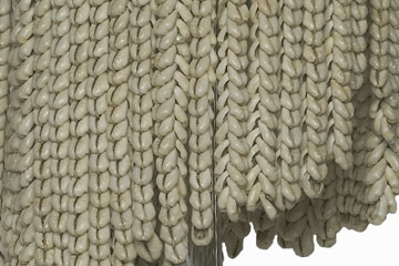 Detail of rows of cowrie shells, threaded together to make a headdress