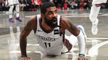 Nets guard Kyrie Irving reacts down on the
