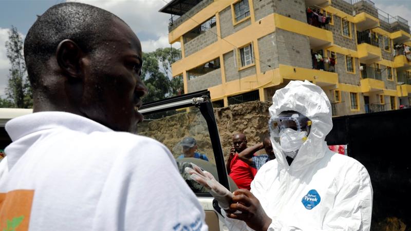 A health worker dressed in a protective suit prepares to disinfect the residence where Kenya's first confirmed coronavirus patient was staying, in Rongai, Kenya, March 14, 2020 [Baz Ratner/Reuters]