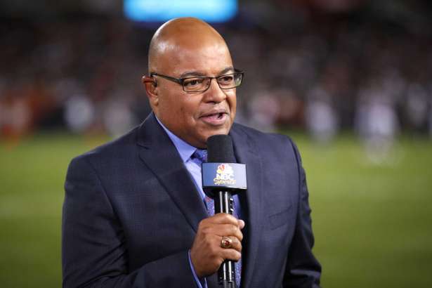 FILE - In this Sept. 5, 2019, file photo, NBC sportscaster Mike Tirico works the sidelines during an NFL football game between the Green Bay Packers and the Chicago Bears in Chicago. Tirico is returning to do a daily talk show, focusing on the coronavirus pandemic's impact on the sports world. "Lunch Talk Live" will air weekdays for an hour, beginning at noon EDT on NBCSN. Tirico will host the show remotely from his home in Michigan.