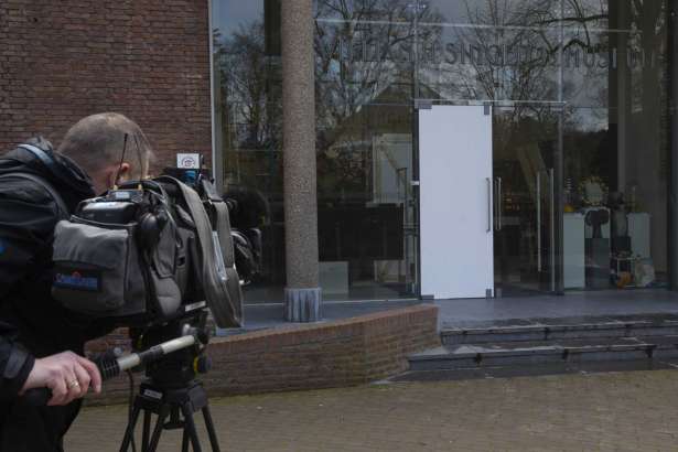 A cameraman films the glass door which was smashed during a break-in at the Singer Museum in Laren, Netherlands, Monday March 30, 2020. Police are investigating a break-in at a Dutch art museum that is currently closed because of restrictions aimed at slowing the spread of the coronavirus, the museum and police said Monday.